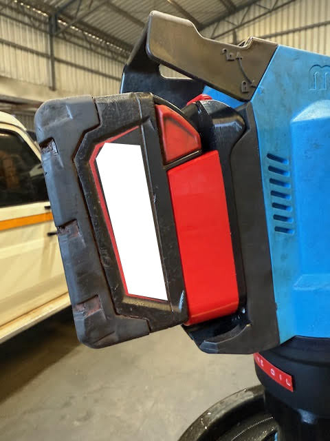 Milwaukee M18 to MacNaught 18V battery adapter - installed on a MacNaught pump with a battery pack fitted, red body in view